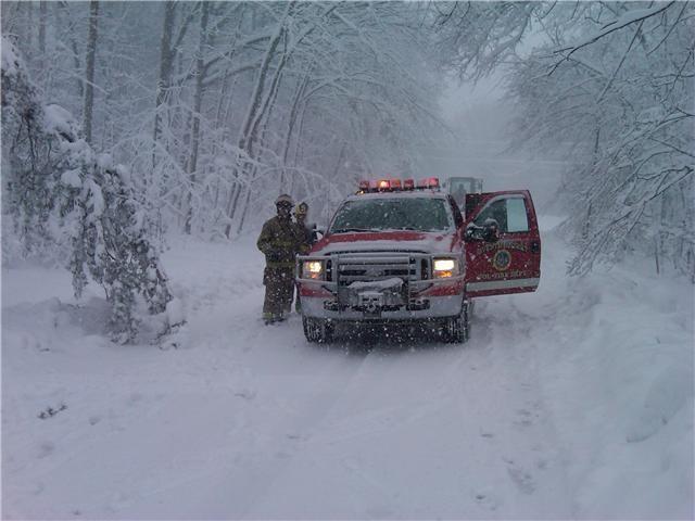 Crew from Brush 5 cutting up trees in the snow
